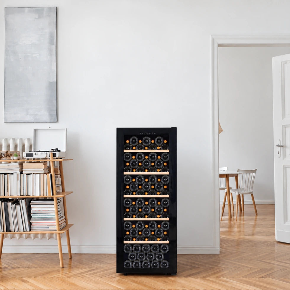 La Sommelière SMART112 wine cooler full of bottles in a bright living room next to a bookcase