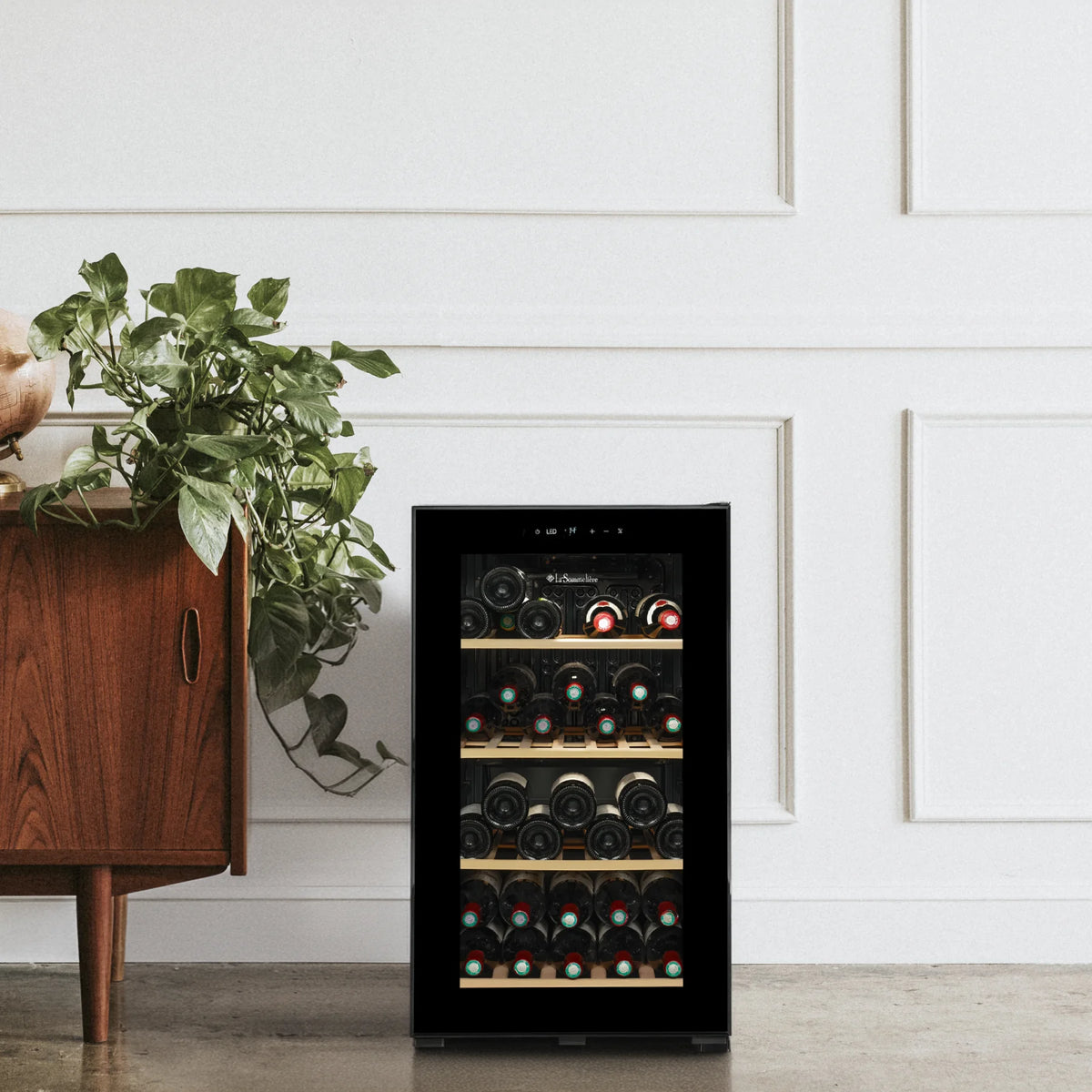 La Sommelière SMART36 34-bottle wine cooler in a living room next to a sideboard