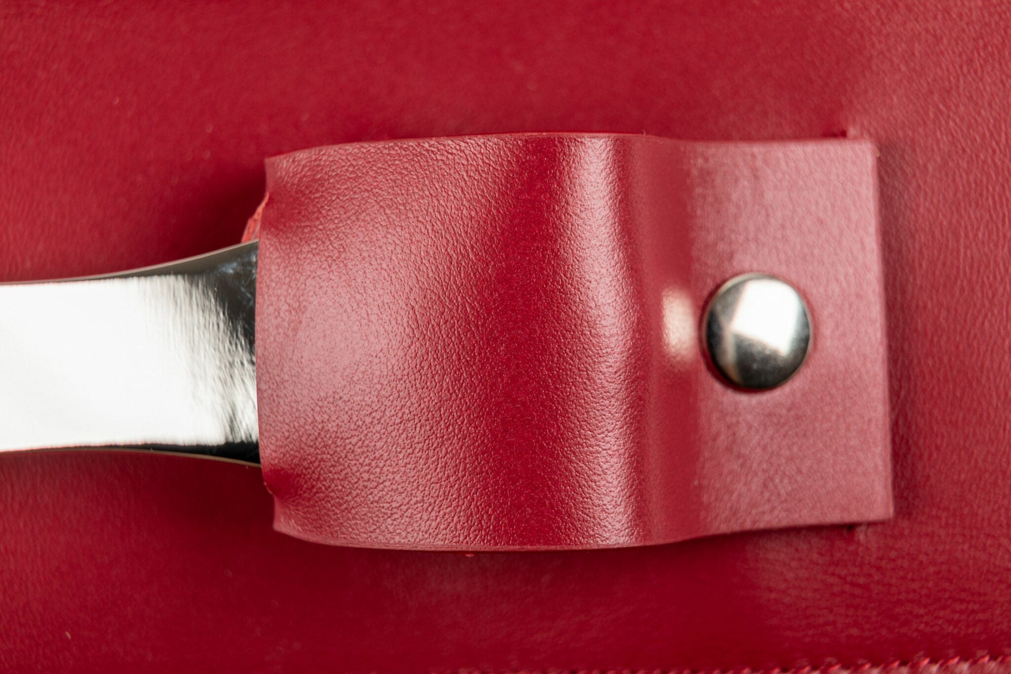 Detalle del mango blanco del sommelier en su portaherramientas de cuero rojo del estuche Oeno Collection Nomad