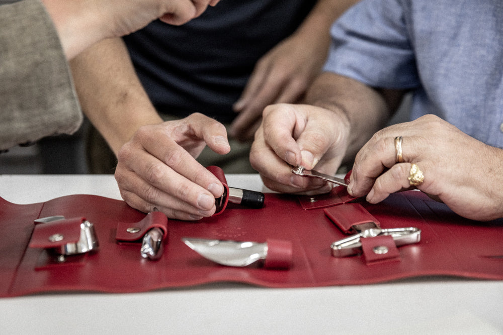 Artesanos de L'Atelier du Vin ensamblando los accesorios de vino en el estuche nómada Oeno Collection Nomad
