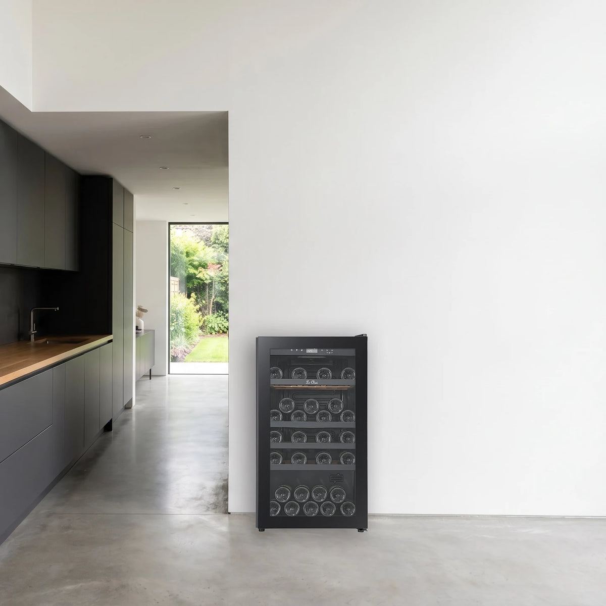 Le Chai LCT1FS49 49-bottle wine cooler, placed in a spacious room next to a kitchen.